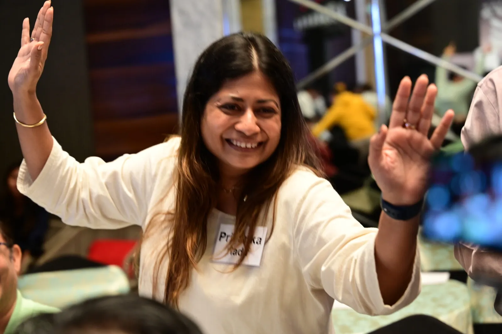 Founder with hands raised, beaming during the workshop